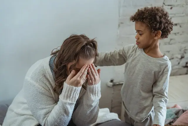 A boy comforting a woman struggling with the challenges of being a stay-at-home mom.