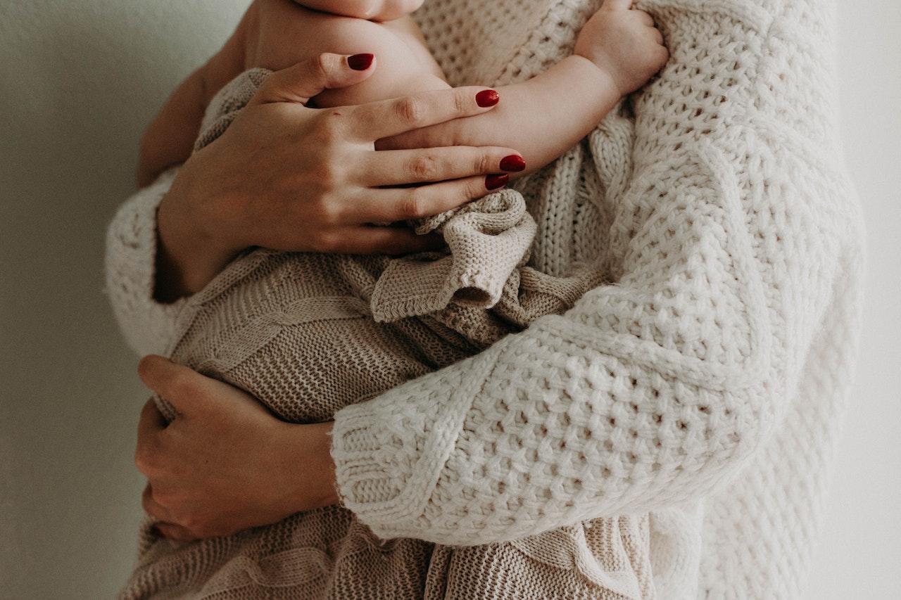Close-up of a woman holding a baby.
