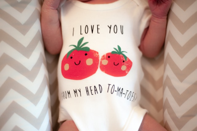 a newborn in a onesie