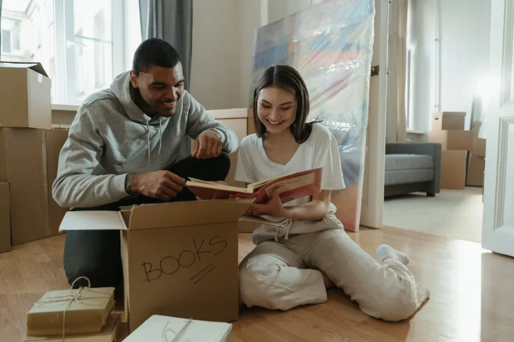Couple organizing family photos during a relocation