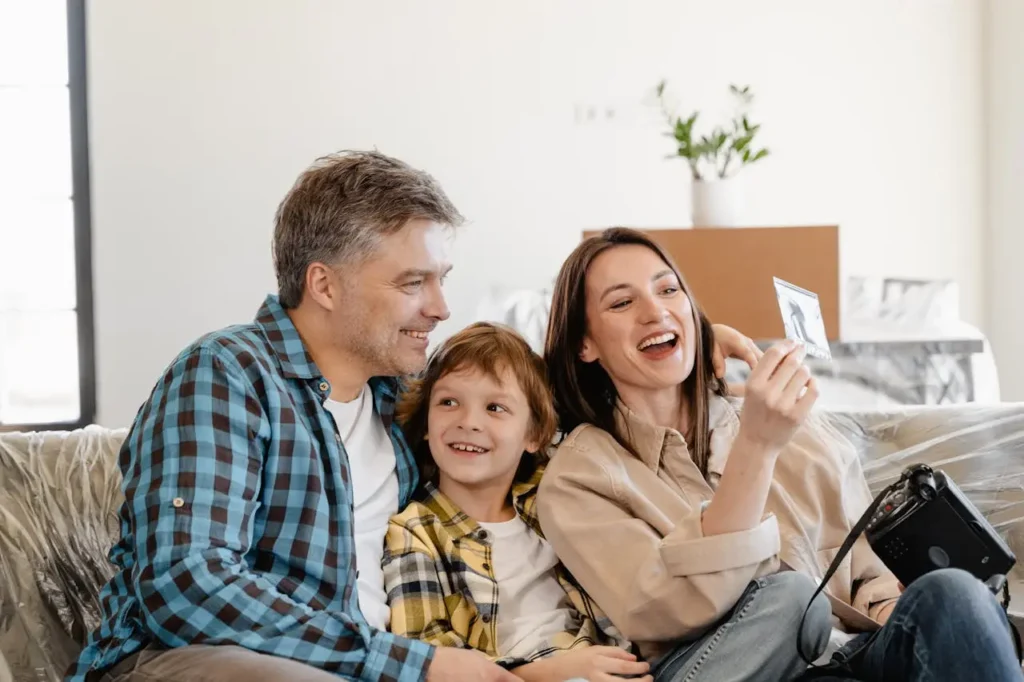 A family capturing a Polaroid photo in a new home
